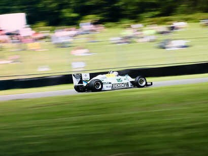 A racing car driving down a race track