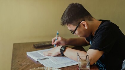 A person sat working at a desk. Concentration is a strategy that focuses on the best point of attack
