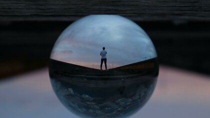 A person through a water droplet showing perspective 