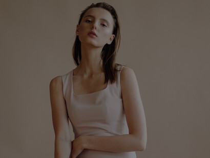 Chic portrait of a young woman in luxurious neutral-toned clothing, exuding elegance and sophistication