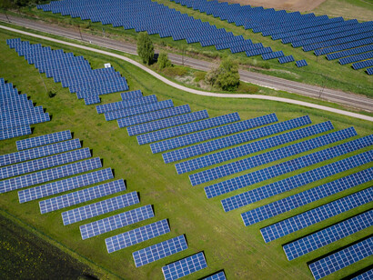 Numerous solar panels in the green fields