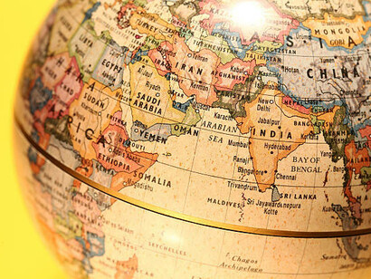 A vintage globe highlighting Pakistan, China, and India on an aged, textured map