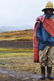 A Lesotho herder wears a Basotho blanket, a covering commonly worn, which has become a national symbol