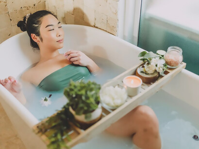 Submerged in the comforting warmth of her bath, a woman revels in self-love, creating a blissful oasis of relaxation as she celebrates Galentine's Day with serene indulgence