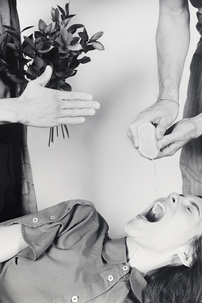 Jenna Westra. Hand Squeezing Lemon into Open Mouth, Onlooker (2018) Gelatin Silver print (Greyscale, framed)
