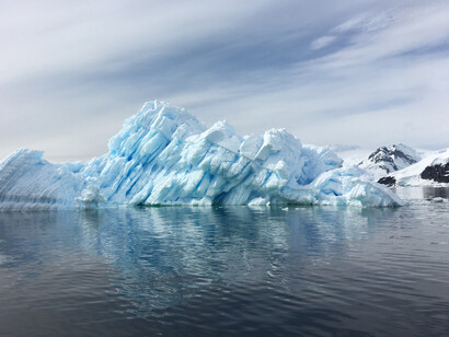 As the world heats up this causes ice sheets and icebergs to melt