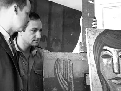 A group of artists from the Espartaco movement evaluate a painting during a studio session
