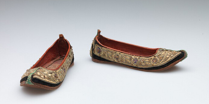 Unknown artist, Indian, Child’s shoes (juttis), late 19th Century, Silk velvet with metallic thread, metal sequin, and stamped metal embellishment, trimmed with leather, Length: 16.5 cm (6 1/2 inches) Gift of Nelson A., Laurence S. and David Rockefeller 56.068