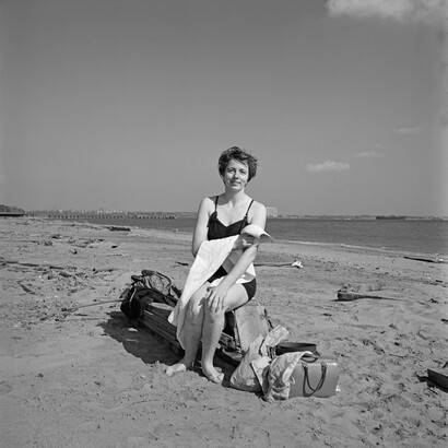 Self-portrait on a beach in New York's Staten Island, 1954, Image size: 12x12 inch (30,48 x 30,48 cm) Paper size: 20x16 inch (50,8 x 40,64 cm) © Estate of Vivian Maier, Courtesy of Maloof Collection and Howard Greenberg Gallery, NY
