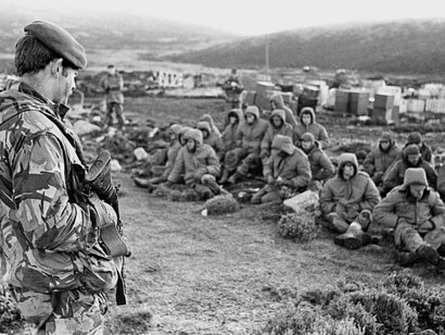 Argentinian soldiers were captured at Goose Green while they were being guarded by a British Royal Marine on 2 June 1982, during the war at Malvinas Islands