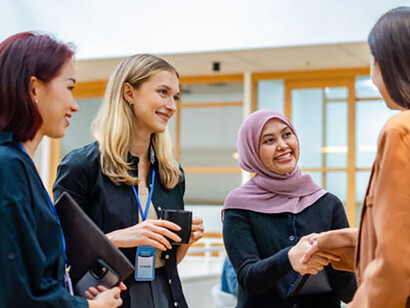 Two businesswomen in a bilateral meeting symbolize traditional diplomatic engagement and mutual understanding