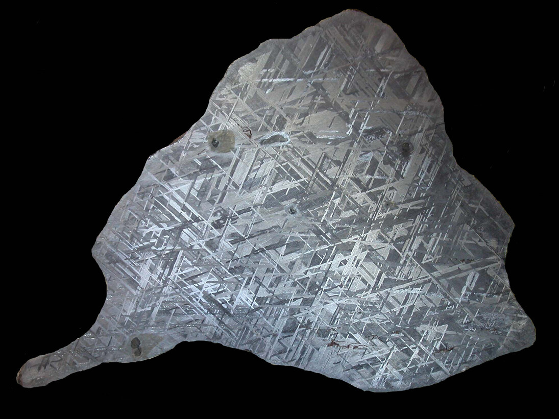 Gibeon endcut black background. A section through an iron meteorite, a natural alloy of iron and nickel. From Gibeon, Namibia
