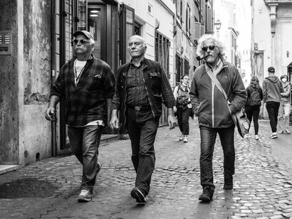 Locals stroll up the street, their steps in sync with the rhythm of the vibrant neighborhood that surrounds them