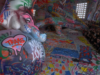 The Diesel FW25 runway show unfolds against a backdrop of giant inflatables crafted from a bold 3km canvas of street art. Created through an open call to graffiti artists worldwide, the installation features work from artists across India, Italy, South Africa, China, Japan, the United States, the United Arab Emirates, and Saudi Arabia
