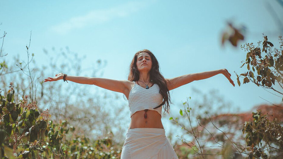 In the serene morning light, a yogini finds balance amidst ancient ruins, blending tradition with contemporary wellness practices