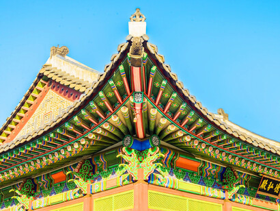 The majestic rooftops of Changdeokgung Palace in Seoul, South Korea, framed by lush greenery, serve as a reminder of Seoul’s ability to preserve its past while embracing the future with architectural innovation