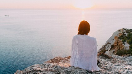 Woman contemplating the sea, looking into herself