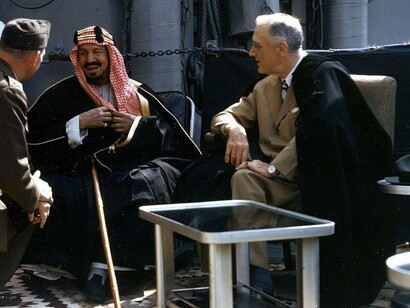 The U.S. President Franklin D. Roosevelt meets with King Ibn Saud of Saudi Arabia, on board the U.S. Navy heavy cruiser USS Quincy (CA-71) in the Great Bitter Lake, Egypt, on 14 February 1945. The King is speaking to the interpreter, Colonel William A. Eddy, USMC