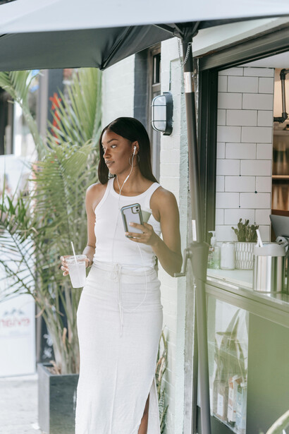 In the comfort of a cozy café, a woman savors her coffee in peaceful solitude