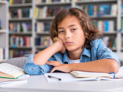 A child surrounded by books yet struggling to engage, symbolising the huge gap between fast content and slow thinking