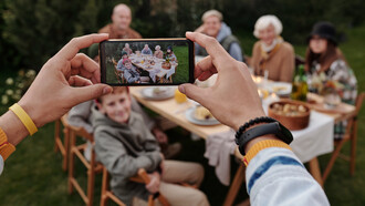A smartphone captures a family having dinner