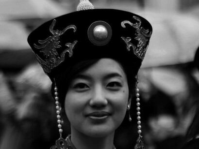 Dressed in stunning traditional attire, she smiles brightly, reflecting the warmth and vibrancy of the Nagasaki Lantern Festival in Nagasaki, Japan, as it lights up the streets of the city