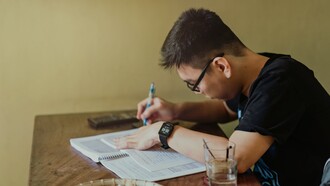 A person sat working at a desk. Concentration is a strategy that focuses on the best point of attack