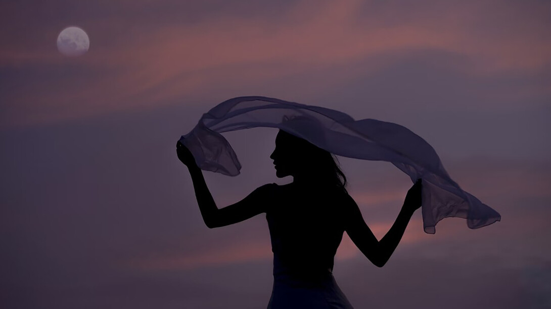 A woman holding a scarf as a symbol of self-expression, empowerment