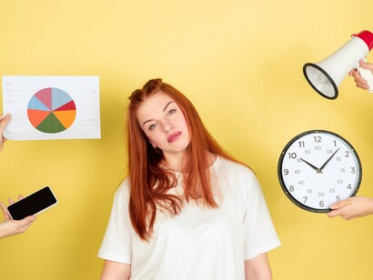 A woman looking tired, frustrated, and overwhelmed by work-related symbols—an illustration of the reduction of human life to a constant pursuit of efficiency