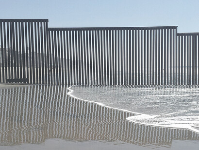 The border fence reaching the Pacific Ocean, from the angle of Border Field State Park in San Diego, California
