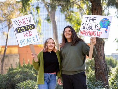 Protesters marching together to address climate change, emphasizing ecofeminism, gender equality, and the critical role of women in protecting the environment