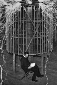 A glow of nitrogen fills the atmosphere as Nikola Tesla is photographed sitting in front of his generator in 1899