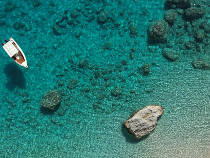 A lone boat drifting in the waters capturing the essence of freedom 