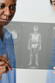 Medical professionals analyzing a patient's X-ray image for accurate diagnosis and treatment planning