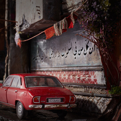 Parked cars, curtains, calligraphy on the walls, and drying laundry are recreated in intricate detail