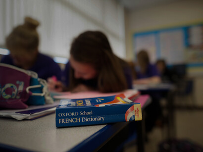 Students busy learning languages, with a French Dictiornary