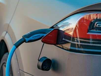 Electrical powered car being charged at a nearby service station