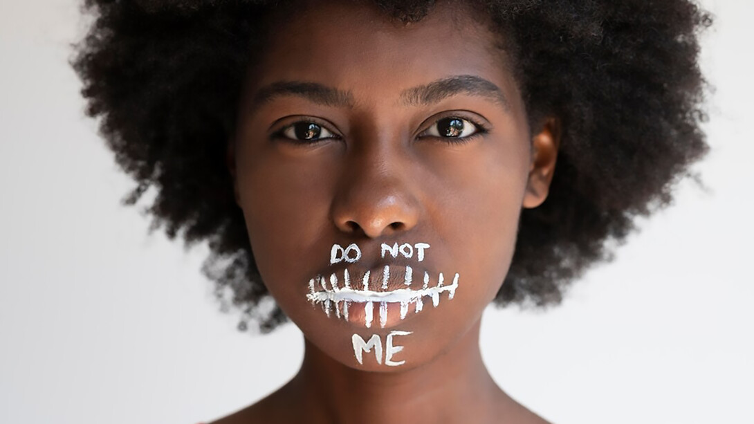 A close-up captures the impassioned expression of a Black woman as she delivers a powerful message of revolution, embodying the spirit of change and empowerment
