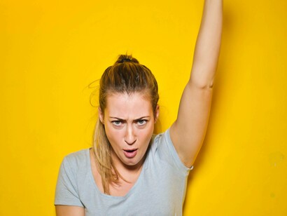 A woman is smiling with her eyes as she tries to contain her happiness